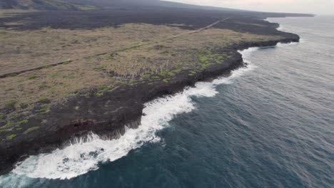 Stunning-aerial-view-of-black-lava-coast-of-the-Big-Island-of-Hawaii,-Crater-Rim-drive