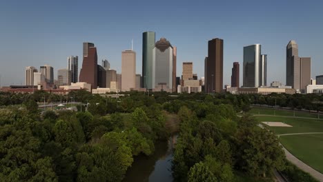 Aerial-drone-view-of-downtown-Houston-skyline-zooming-out-over-Buffalo-Bayou-Park-in-Houston-Texas
