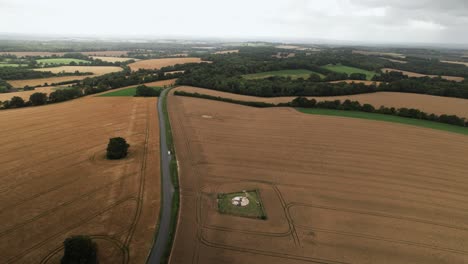 Establishing-aerial-view-towards-Beauworth-2023-crop-circle-atomic-pattern-on-Hampshire-wheat-farmland