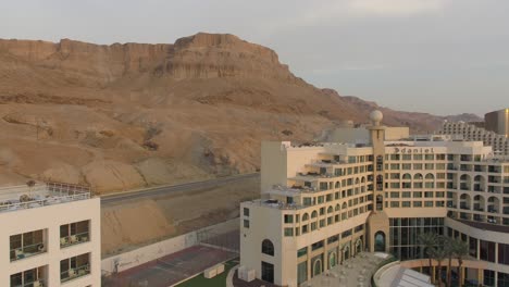 Dead-Sea-hotels-and-waterfront-highway-on-a-beautiful-morning,-Aerial-view