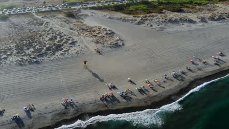 Drone-footage-reversing-back-and-filming-the-waves-rolling-in-on-the-beach
