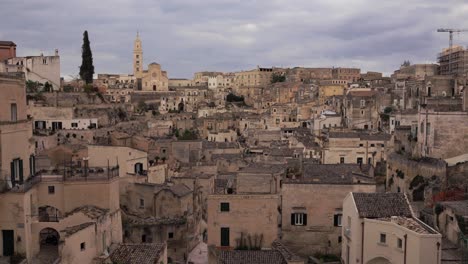 A-steady-panoramic-view-of-Matera,-the-city-landscape-with-wonderful-historic-landmarks,-church-and-caves