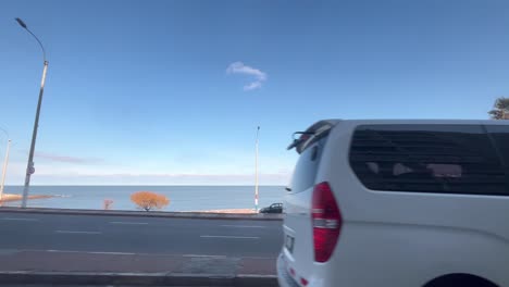 Driving-in-Montevideo-along-the-coastal-road-Rambla-Republica-del-Peru-arriving-at-the-corner-of-Playa-Pocitos---Bajada-Buxareo