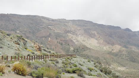 Remote-road-leafing-through-majestic-Teide-national-park-landscape,-pan-right