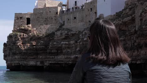 A-lovely-girl-enjoying-a-picturesque-view-of-Polignano-a-Mare