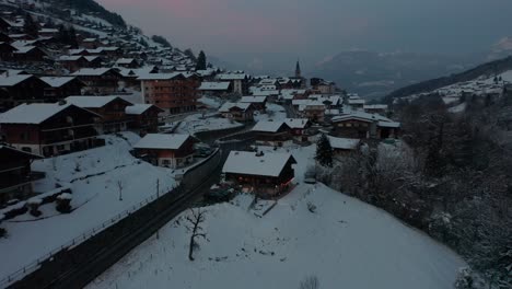Aerial-of-a-beautiful-home-in-a-rural-town-in-a-snow-covered-landscape-at-dusk