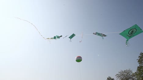 Thousands-of-kites-fly-into-the-sky-at-the-International-Kites-Festival,-a-long-line-of-kites-flying-high-into-the-sky