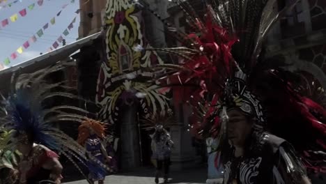Slow-motion-shot-of-tribal-dancers-wearing-religious-clothing-dancing-in-the-street