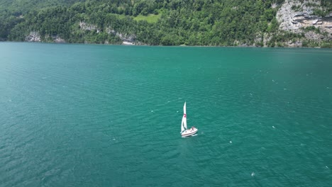 Lonely-Yacht-sets-on-adventurous-journey-in-Walensee-lake,-Switzerland