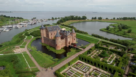 Muiderslot-castle:-aerial-view-traveling-in-on-one-side-of-the-beautiful-castle-and-where-you-can-see-the-port-and-the-channels-that-surround-it