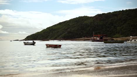 Handheld-fishing-boats-on-the-shore-of-Tartaruga-beach-in-Búzios,-Brazil