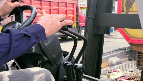 Close-up-shot-of-forklift-male-operator-hands-on-the-levers-control