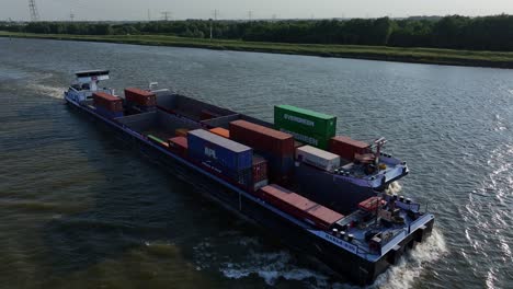 Loaded-cargo-ship-sailing-through-the-river,-Aerial-view