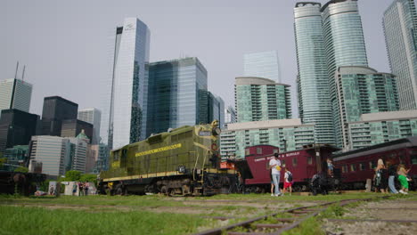 People-Visit-Outdoor-Railway-Museum,-Toronto-Downtown,-Low-Angle-SLOMO