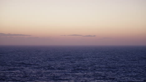 Slow-Motion-Ocean-Waves-With-Orange-Sunset-On-Horizon,-4K