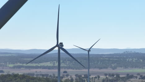Close-Up-Drone-Flying-In-Wind-Turbines-Overlooking-Australian-Countryside,-4K-Telephoto
