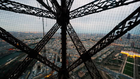 Ascending-up-the-Eiffel-Tower-looking-out-over-downtown-Paris-at-dusk