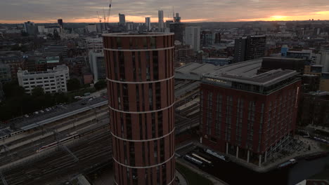 Rising-Establishing-Aerial-Drone-Shot-of-Candle-House-and-Leeds-City-Centre-at-Sunrise