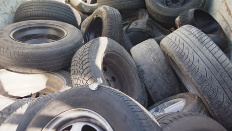 Closeup-shot-of-end-of-life-discarded-car-tyres-lying-on-pile-at-tyre-graveyard