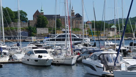 Fjord-Cruise-Electric-Vessel-in-Oslo-marina,-moored-boats-in-foreground