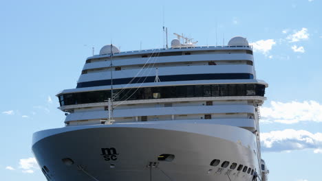 Close-up-tilt-up-shot-of-MSC-ocean-liner-docked-on-sunny-day