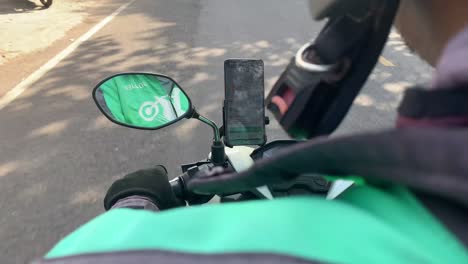 Indonesia---Jul-22,-2023-:-motorcycle-rear-view-mirror-with-Gojek-logo