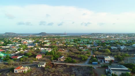 4.000-Drones-Revelan-Casas-Y-Vecindarios-Cerca-Del-Mar-Caribe-En-Curazao,-Plataforma-De-Perforación-Petrolera-Atracada-En-La-Distancia