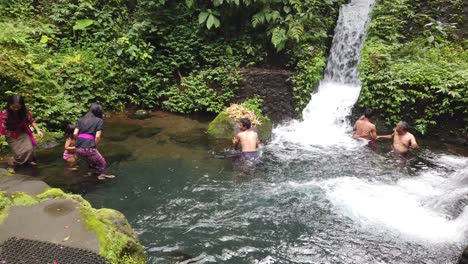 Balinese-People-Bath-at-Water-Ritual-Temple-Purification-Waterfall-in-Mengening-Family-of-Hindu-Bali-Religion-in-Tropical-Jungle