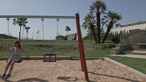 Little-Caucasian-Girl-Swings-Playground-Hammocks-Spain-Countryside-Panoramic-View,-Calders,-Catalonia,-Barcelona