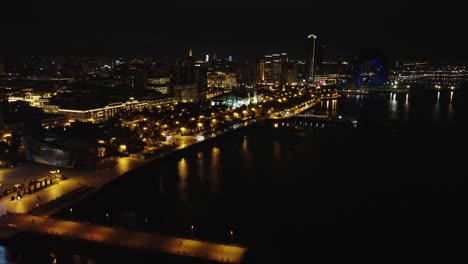 Aerial:-Illuminated-Caspian-waterfront-of-Baku-city-in-Azerbaijan
