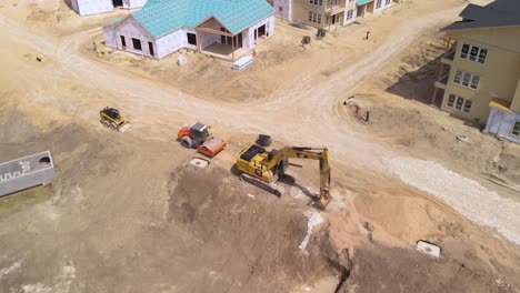 Aerial-Drone-View-of-Apartment-Homes,-Roofs,-Trusses,-Cranes,-Boom-Lifts,-Tractors---Residential-Building-Construction-Site-In-Austin,-Texas,-USA