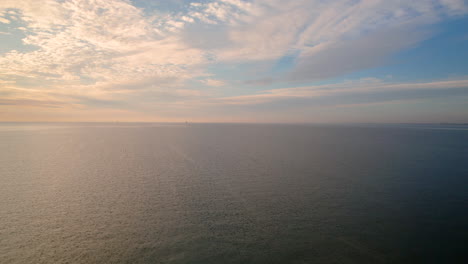 Vivid-orange-sunrise-colors-over-Baltic-Sea,-high-angle-horizon-view-over-ocean