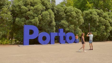 Tourists-near-the-sign-Porto-in-Portugal