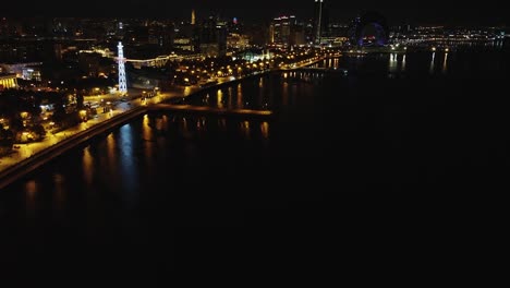 Dark-night-aerial-flight-along-Caspian-Sea-promenade,-Baku-Azerbaijan