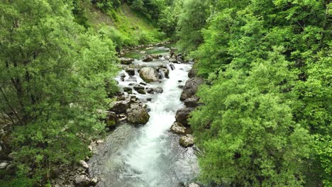 Panoramic-Aerial-Landscape-of-Logar-Valley-Slovenian-Natural-Water-River-Flow-between-Green-Lush-Forest