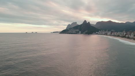 Aerial-Drone-Panoramic-Landscape,-Rio-de-Janeiro-Leblon-Beach-Brazil-Hills-City-Skyline-at-Warm-Pink-Sunset,-Establishing-Shot
