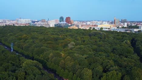 Brandenburg-Gate-Magic-aerial-top-view-flight-CSD-Pride-Parade-2023-city-Berlin-Germany-Summer-evening-Victory-Column