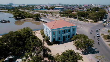 aerial-view-of-Blue-House,-lovingly-named-Ministerio-de-Cultura,-graces-the-landscape-as-a-cultural-jewel,-an-ode-to-tradition-and-innovation,-complemented-by-the-bustling-cityscape-in-the-background