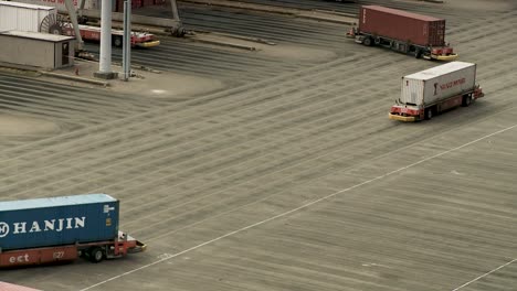 Autonomous-cargo-container-transport-system-on-international-harbour,-telephoto