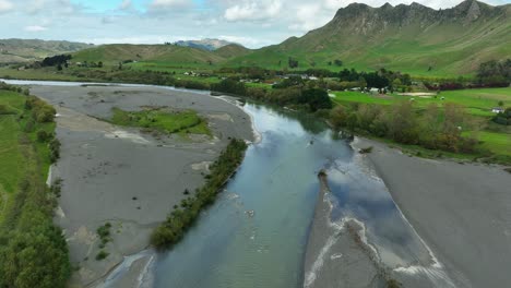 Tukituki-river-flowing-naturally-through-valley-in-New-Zealand,-aerial