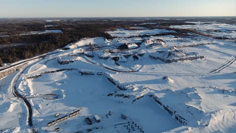 Aerial-view-of-limestone-quarry-in-Canada-covered-in-snow-during-winter