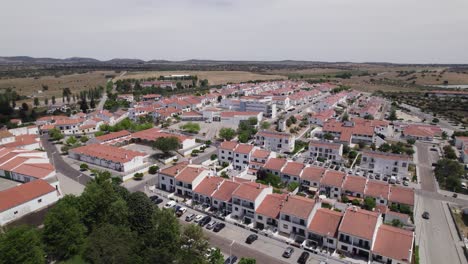 Aerial-view-orbiting-whitewashed-homes-with-terracotta-tiled-rooftops-in-Arronches-neighbourhood-municipality-of-sunny-Portugal