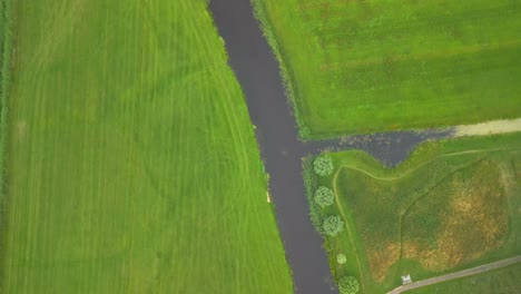 aerial-looking-down-at-green-fields-and-flooded-canals-due-to-climate-change