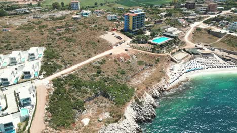 Albania,-a-hotel-with-a-pool-by-the-beach-with-azure-waters-of-the-Ionian-Sea
