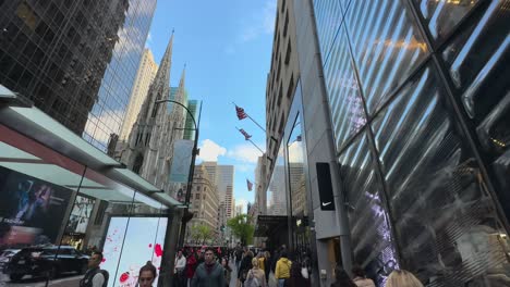POV-Pan-Down-From-Looking-Up-At-Skyscrapers-Walking-Along-5th-Avenue-In-New-York