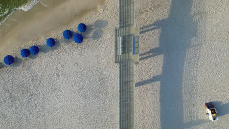 Top-down-aerial-view-of-pier-located-on-Orange-Beach
