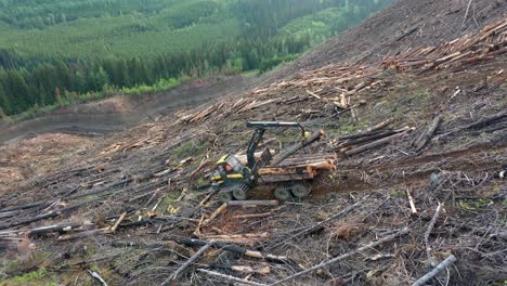 Drone-Perspective:-Forwarder-Loading-Timber-on-Mountainous-Trail