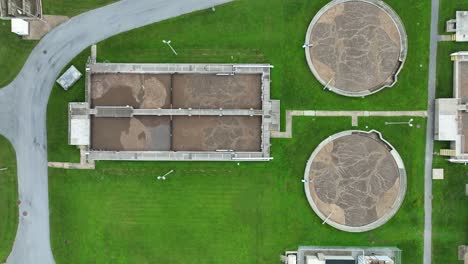 Top-down-aerial-shot-of-water-treatment-plant-with-wastewater-tanks