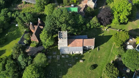 An-upward-tilt-shot-of-St-Andrew's-church,-tilting-up-to-show-the-village-of-Wickhambreaux