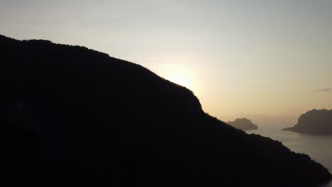 Sunset-over-Palawan-islands,-mountain-silhouette-foreground